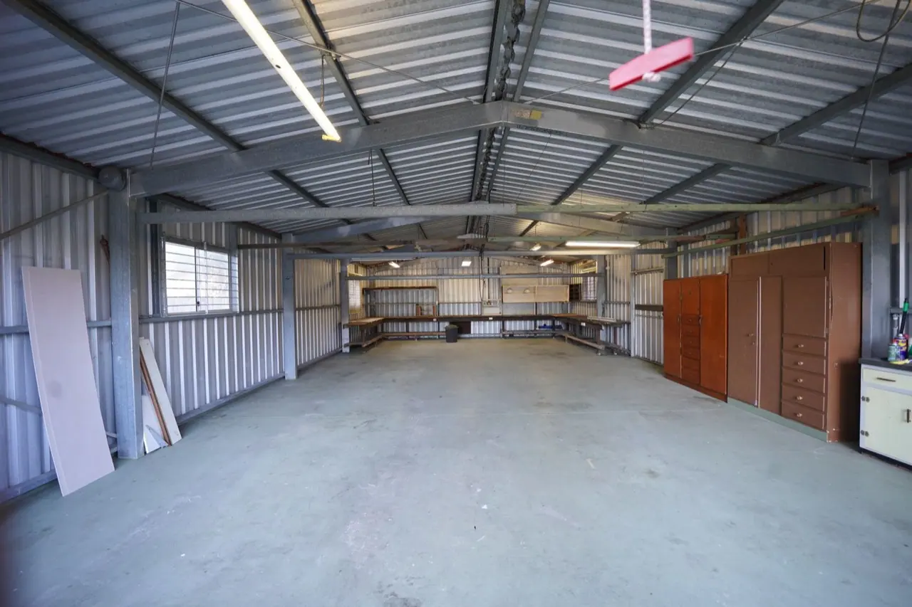 An empty warehouse with a concrete floor and high ceiling